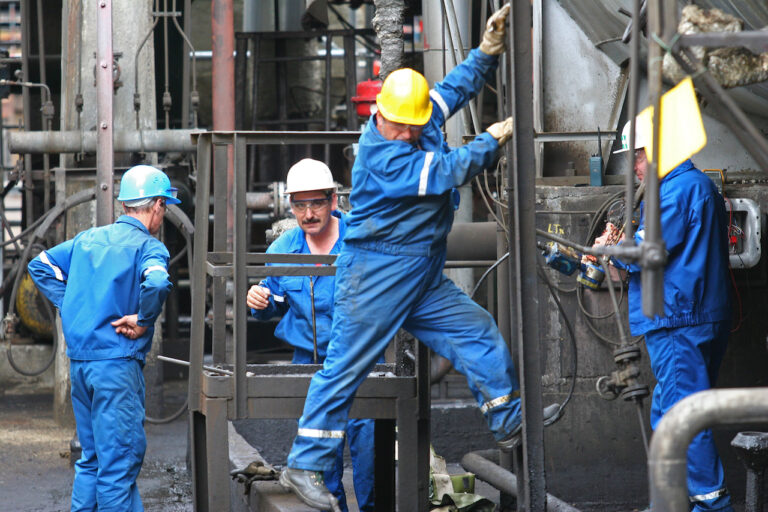 bucharest, romania nov 9: oil workers perform maintenance duties at the arpechim refinery near pit